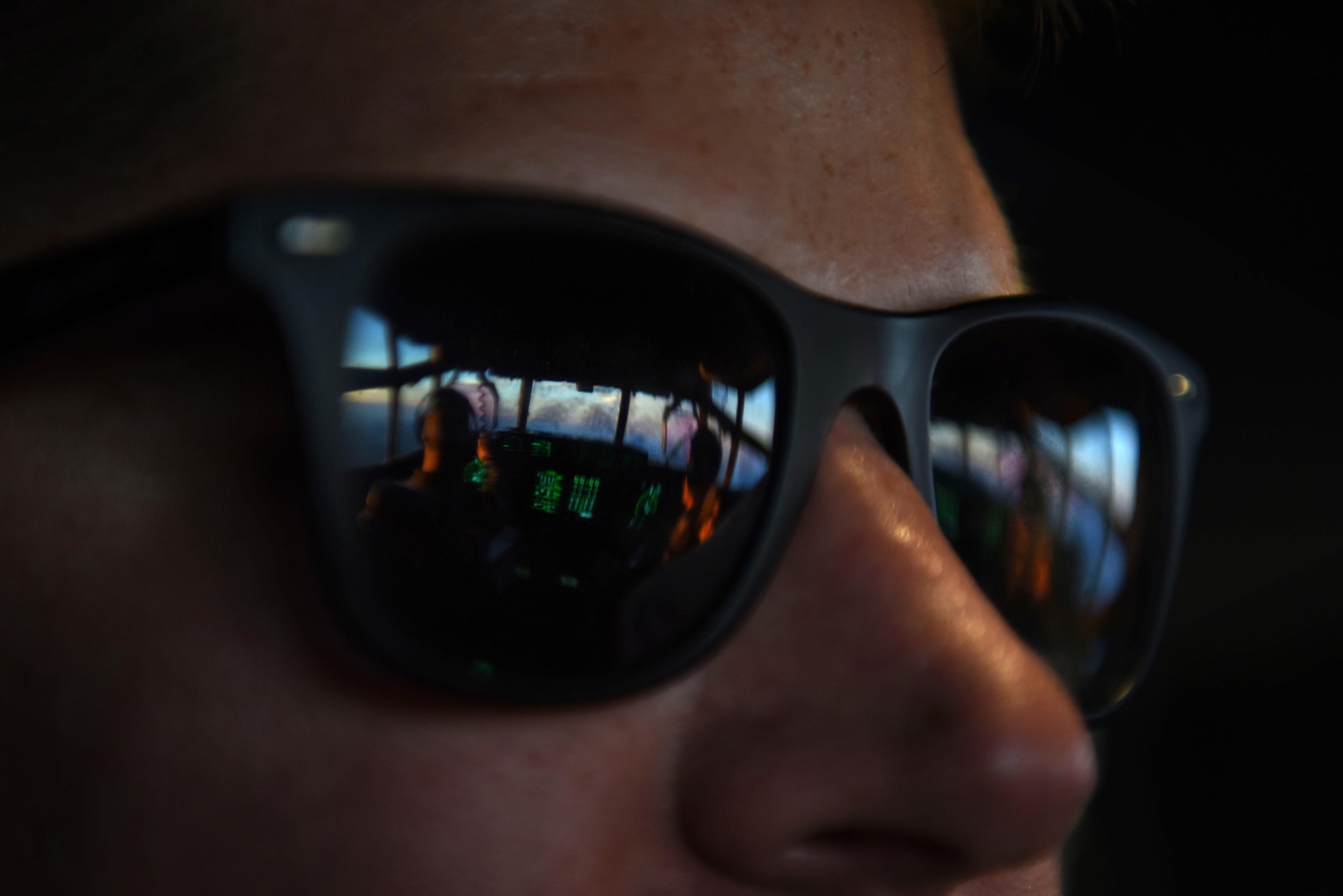 U.S. Air Force Senior Airman Mason Forbush, 19th Aircraft Maintenance Squadron crew chief, looks out onto the flight deck mid-flight on a C-130J headed to Haiti Oct., 8, 2016. The C-130J, flown by the 61st Airlift Squadron, delievered supplies and personnel as part of humanitarian effort to Haiti in the wake of Hurricane Matthew, a Category 4 hurricane. (U.S. Air Force photo by Senior Airman Mercedes Taylor)