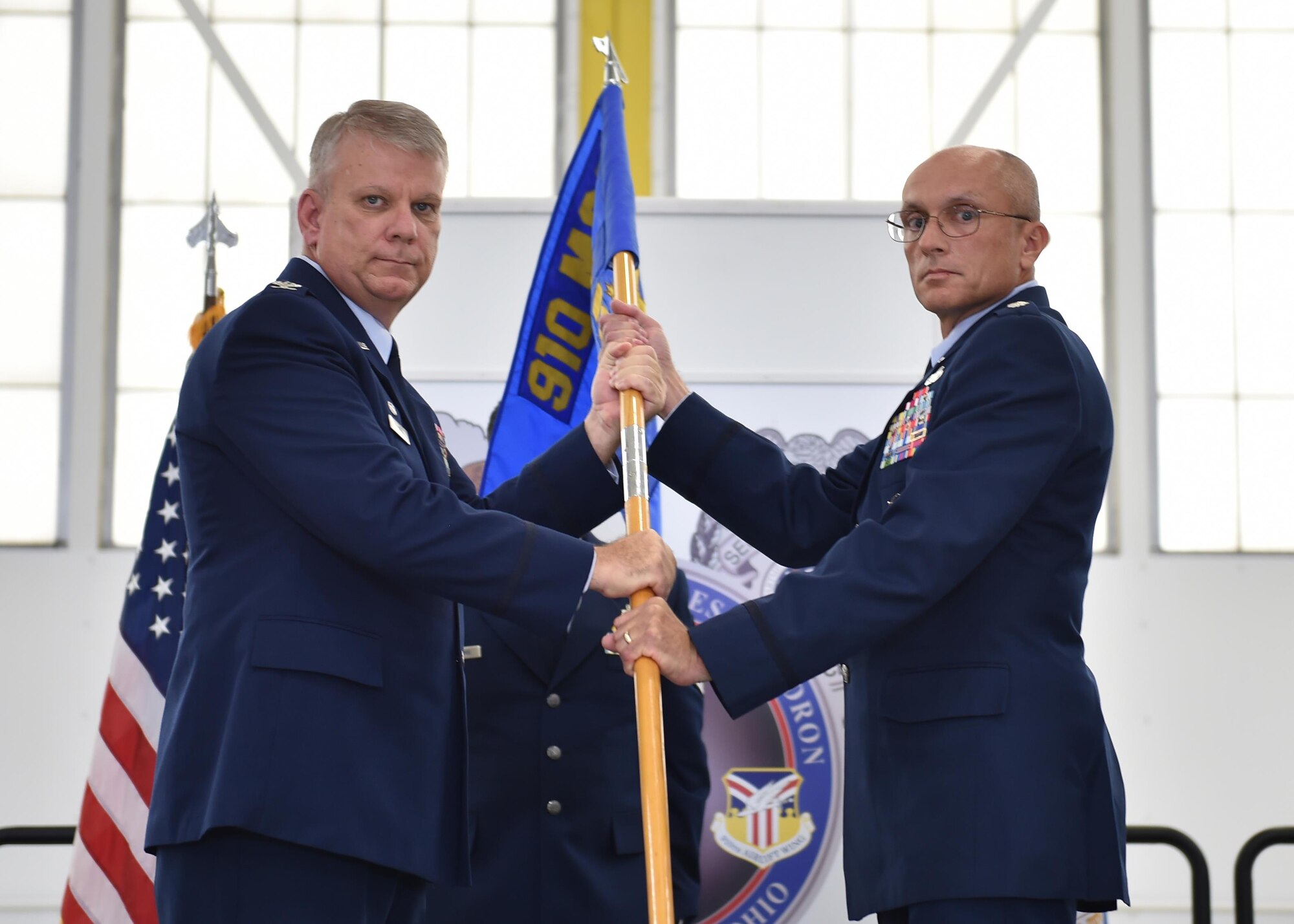 Lt. Col. Scott Stewart, new commander of the 910th Security Forces Squadron, receives a unit guidon, or flag, from Col. Donald Wren, 910th Mission Support Group commander here, Oct. 1, 2016. Stewart took command of his new squadron at a ceremony during the Unit Training Assembly (UTA). (U.S. Air Force photo/Staff Sgt. Rachel Kocin)