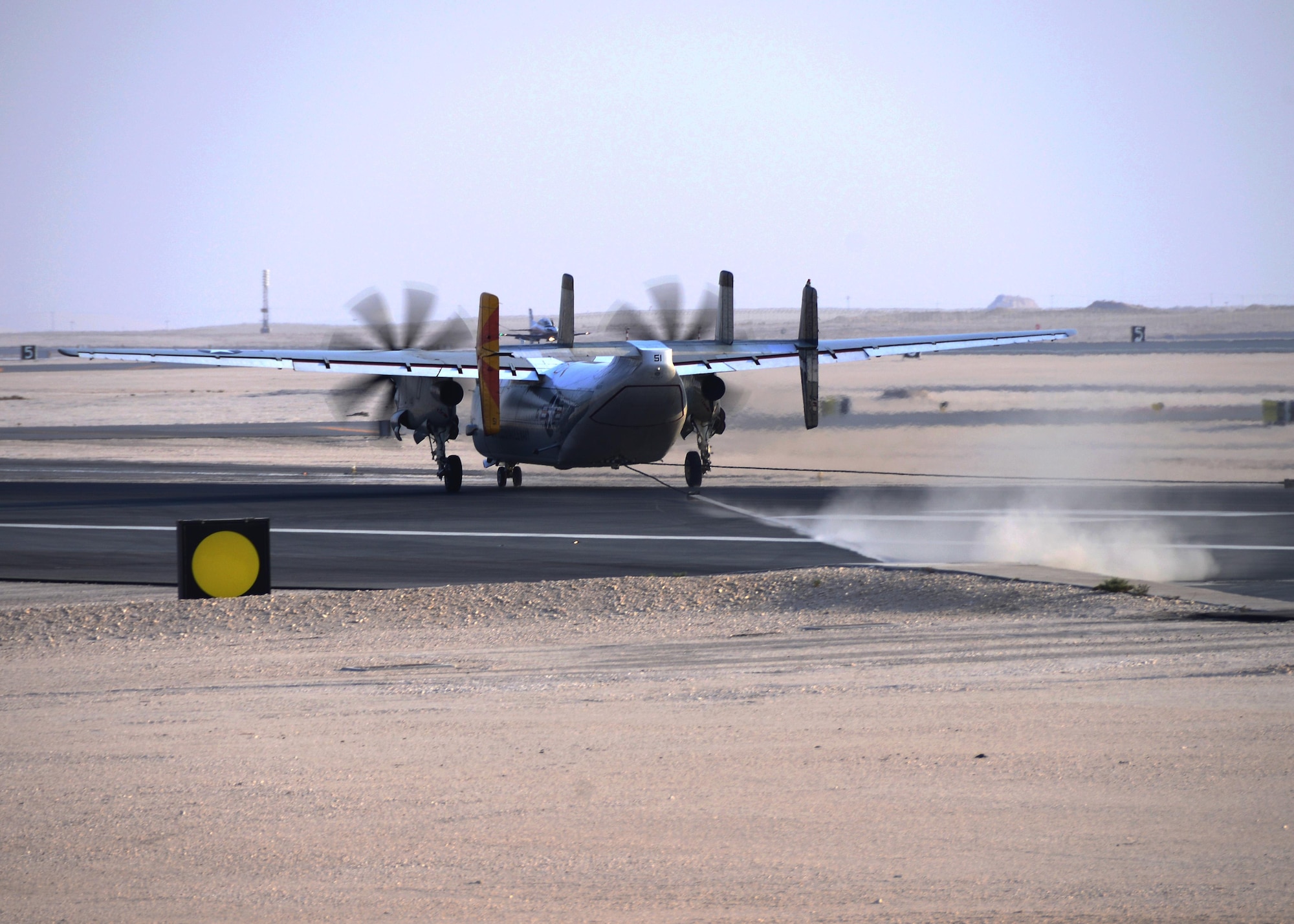 A U.S. Navy C-2A Greyhound tests the Aircraft Arresting System on the flight line Oct. 9, 2016, at Al Udeid Air Base, Qatar. The AAS is used in the event that an emergency stop or landing is needed to prevent potential harm to both pilot and aircraft. The system consists of a cable that runs along the width of the runway, and can be raised and lowered by the barrier arresting kit known as the BAK-14. (U.S. Air Force photo/Senior Airman Miles Wilson/Released)
