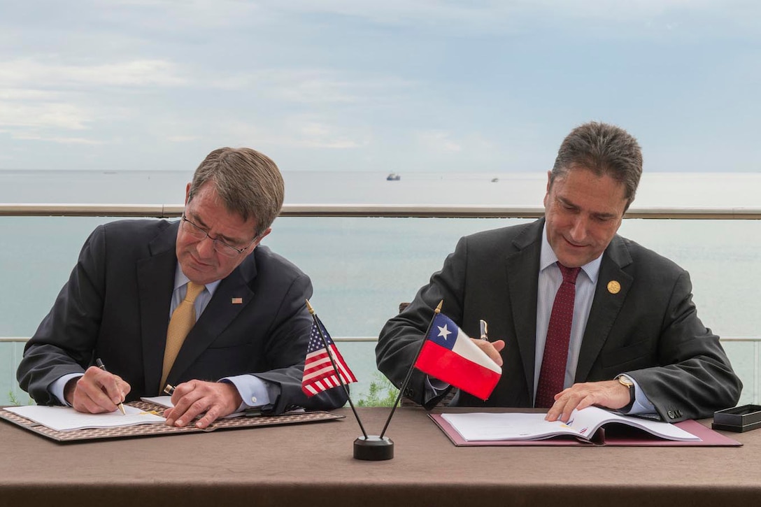Defense Secretary Ash Carter signs an agreement with Chilean National Defense Minister Jose Gomez during the Conference of Defense Ministers of the Americas in Port-of-Spain, Trinidad and Tobago, Oct. 11, 2016. The agreement will expand cooperation between the two countries on defense technology. DoD photo by Air Force Tech. Sgt. Brigitte N. Brantley 