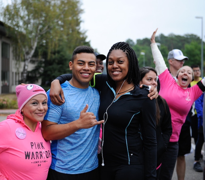 Runners pose before the start of a breast cancer awareness 5 km run at Ramstein Air Base, Germany, Oct. 8, 2016. The event was free and available to anyone, and the first 25 people that registered online got a free t-shirt. (U.S. Air Force photo by Airman 1st Class Savannah L. Waters)