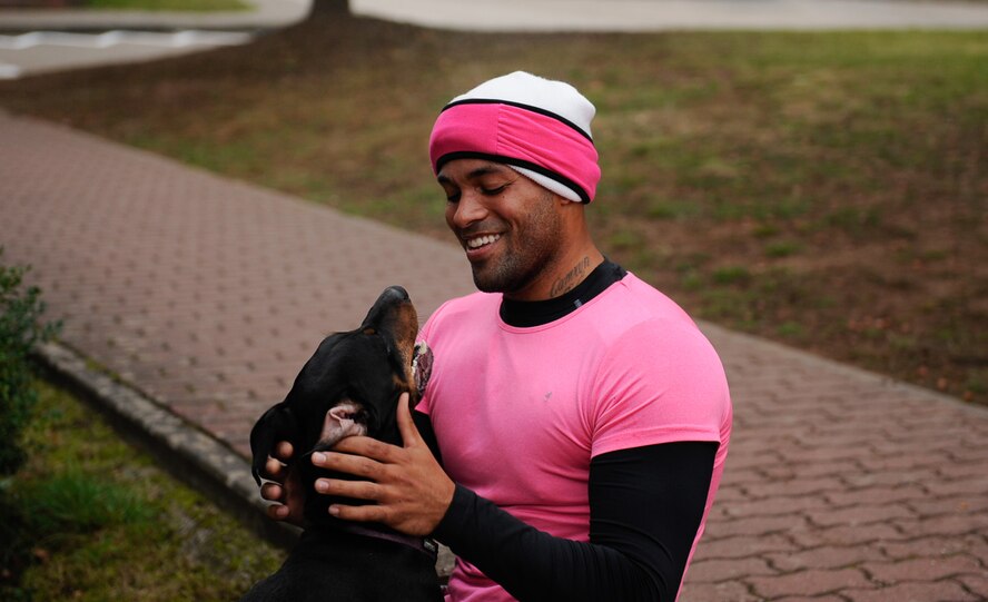 Staff Sgt. Spencer Wallace, 435th Security Forces Squadron training operations NCO in charge, cools down with his dog Aaliyah after a breast cancer awareness 5 km run at Ramstein Air Base, Germany, Oct. 8, 2016. After finishing their run, Wallace and Aaliyah ran back to run with others as they crossed the finish line. (U.S. Air Force photo by Airman 1st Class Savannah L. Waters)