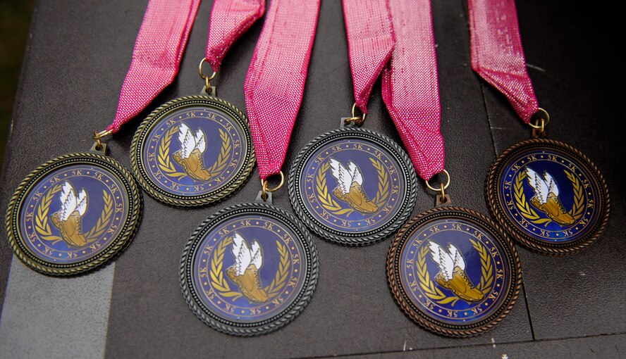 Medals are displayed for a breast cancer awareness 5 km run at Ramstein Air Base, Germany, Oct. 8, 2016. Medals were awarded to the top three male and female runners, as well as the top team. (U.S. Air Force photo by Airman 1st Class Savannah L. Waters)


