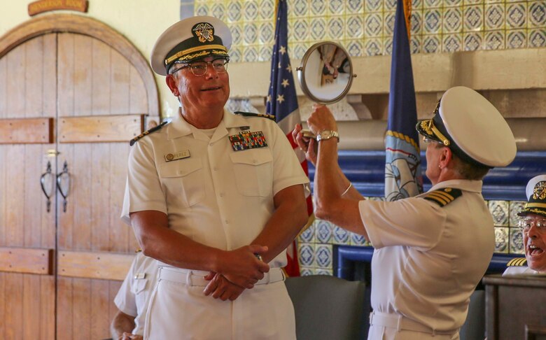 Commander Patty Miller (ret.) holds a mirror up to Cmdr. Rafael C. Perez (ret.), division officer, Sports and Medicine Rehabilitation Center, during his retirement ceremony at the Bay View Restaurant at MCRD San Diego, Oct. 7. Perez served for 44 years and three months in the U.S. Navy, and he was deployed several times. Miller asked Perez what he saw in the mirror and he responded with, “the greatest grandfather in the world.”