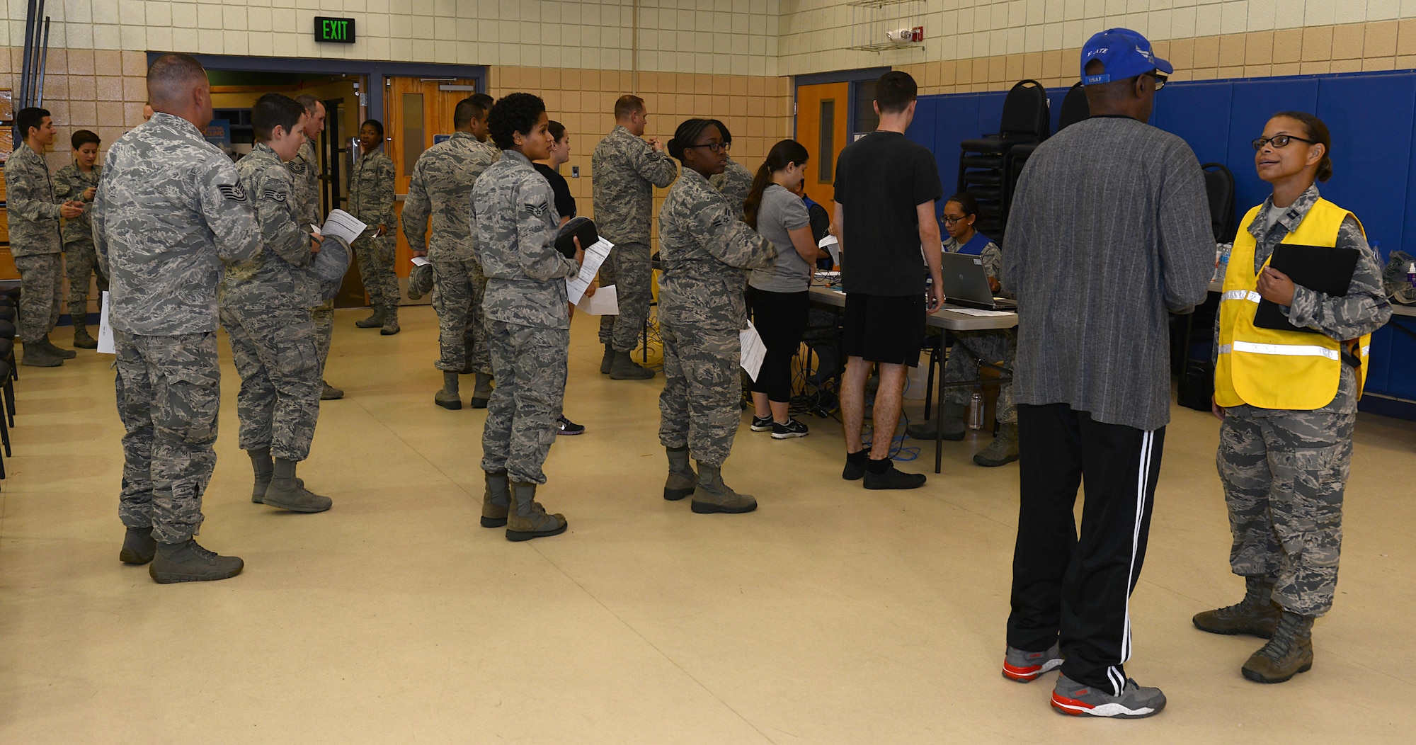 U.S. Airmen wait in line to get signed-off after receiving their flu vaccine during the flu point-of-distribution exercise at the Langley Community Commons, Joint Base Langley-Eustis, Va., Oct. 5, 2016. To avoid long wait times, Airmen were encouraged to visit the POD during the time scheduled for their unit. (U.S. Air Force photo by Staff Sgt. Teresa J. Cleveland)