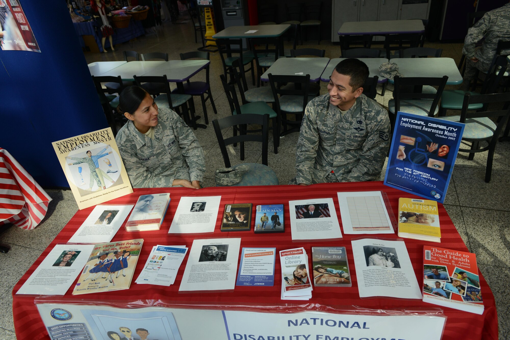 Staff Sgt. Blanca Gama, 86th Aeromedical Evacuation Squadron noncommissioned officer in charge of resource management (left), and Staff Sgt. Julio Parnas Jr., 86th Logistics Readiness Squadron cargo deployment function supervisor, volunteer at an educational booth for National Disability Employment Awareness Month at Ramstein Air Base, Germany, Oct. 5, 2016. NDEAM aims to give voice to people who may be struggling to find employment because of their physical, mental or emotional disabilities. (U.S. Air Force photo by Airman 1st Class Joshua Magbanua)