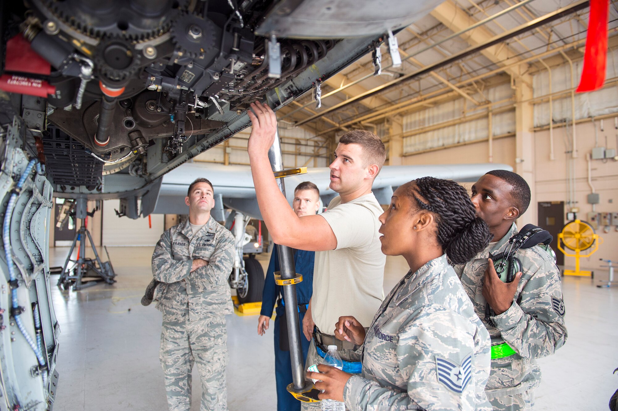 U.S. Air Force Senior Airman Joshua Abbott, 74th Aircraft Maintenance Unit aircraft armament systems technician, explains to Tech. Sgt. Netasha Hutto-Harris, 23d Medical Support Squadron NCO in charge of medical evaluation boards, the weaponry aspects of an A-10C Thunderbolt II, Oct. 6, 2016, at Moody Air Force Base, Ga. Hutto-Harris says she appreciated the chance to glimpse into the life of a maintainer. (U.S. Air Force photo by Airman 1st Class Greg Nash)