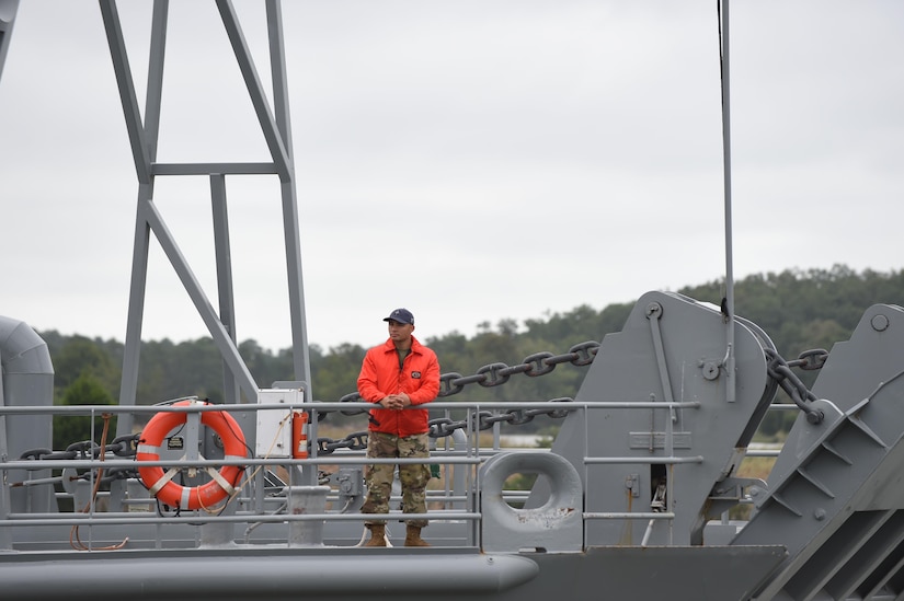 A U.S. Army Soldier with the 7th Transportation Brigade (Expeditionary) looks to Third Port as he departs Joint Base Langley-Eustis, Va., Oct. 7, 2016. As a precautionary measure larger vessels traveled north to avoid potential damage due to Hurricane Matthew. (U.S. Air Force photo by Staff Sgt. Natasha Stannard) 