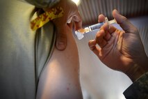 A medical technician administers an influenza vaccination to an Airman on Laughlin Air Force Base, Texas, Oct. 4, 2016. Flu vaccines are available at the Laughlin Immunization Clinic to all military members, their families and retirees. (U.S. Air Force photo/Senior Airman Ariel D. Partlow)