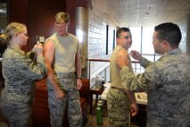 Senior Airman Sara Valeski (left), 47th Medical Operations Squadron Flight Medicine medical technitian, and Staff Sgt. Shon Nguyen (right), 47th MDOS Family Health flight chief, administer influenza vaccinations to Col. Thomas Shank (second from the left), 47th Flying Training Wing commander, and Chief Master Sgt. George Richey, 47th FTW command chief on Laughlin Air Force Base, Texas, Oct. 4, 2016. The Laughlin Immunization Clinic will be available to provide free flu vaccines from 7:30 until 11:45 a.m. and 1 until 4 p.m. Monday through Friday. (U.S. Air Force photo/Senior Airman Ariel D. Partlow)