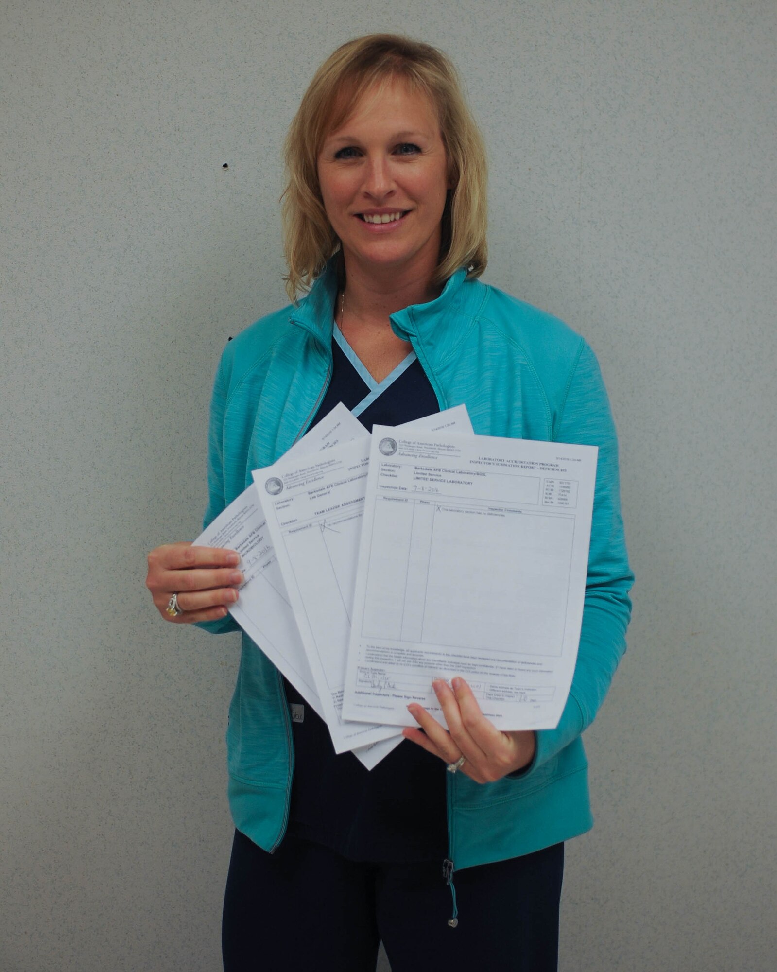 Rebecca Harris, 2nd Medical Support Squadron quality assurance coordinator, holds inspection reports from the College of American Pathologists at Barksdale Air Force Base, La., Sept. 22, 2016. The purpose of the inspection is to ensure the Clinical Laboratory Improvement Act of 1988 is enforced throughout all medical laboratories in the US. (U.S.Air Force photo/Airman 1st Class Stuart Bright)