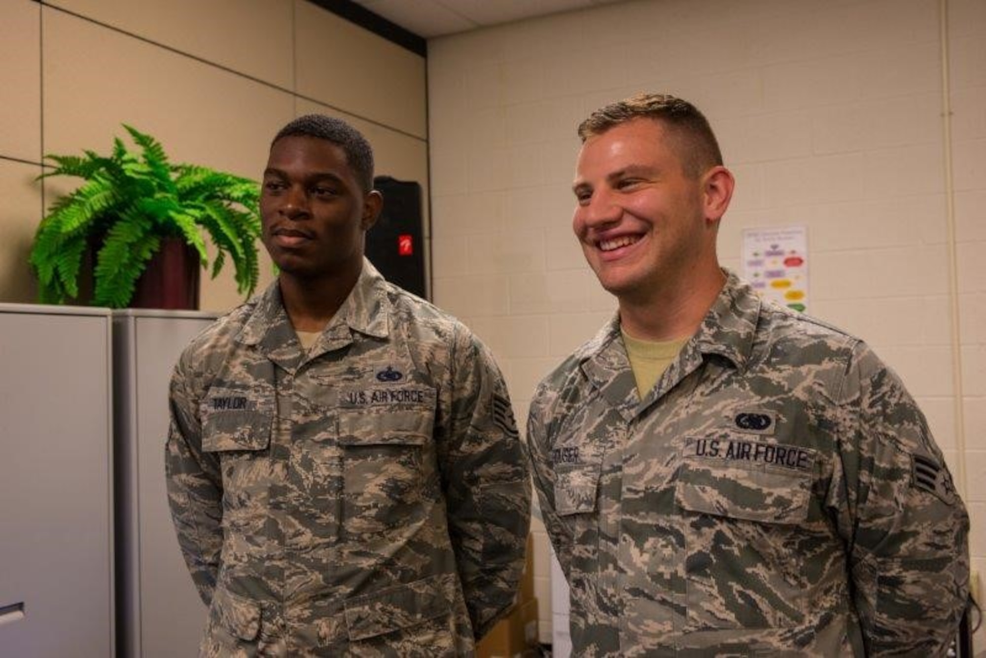 U.S. Air Force Staff Sgt. Terell Taylor, 440th Supply Chain Operations Squadron centralized equipment technician, and U. S. Air Force Senior Airman Maxwell Houser, 440th SCOS equipment authorization journeyman, discuss the benefits of teamwork after the 440th SCOS Equipment Transformation graduation at Joint Base Langley-Eustis, Va., Oct. 6, 2016. The 440th SCOS uses Enterprise Solution-Supply processes to provide centralized retail equipment management support to maintainers worldwide. (U.S. Air Force photo by Danny Mangosing)