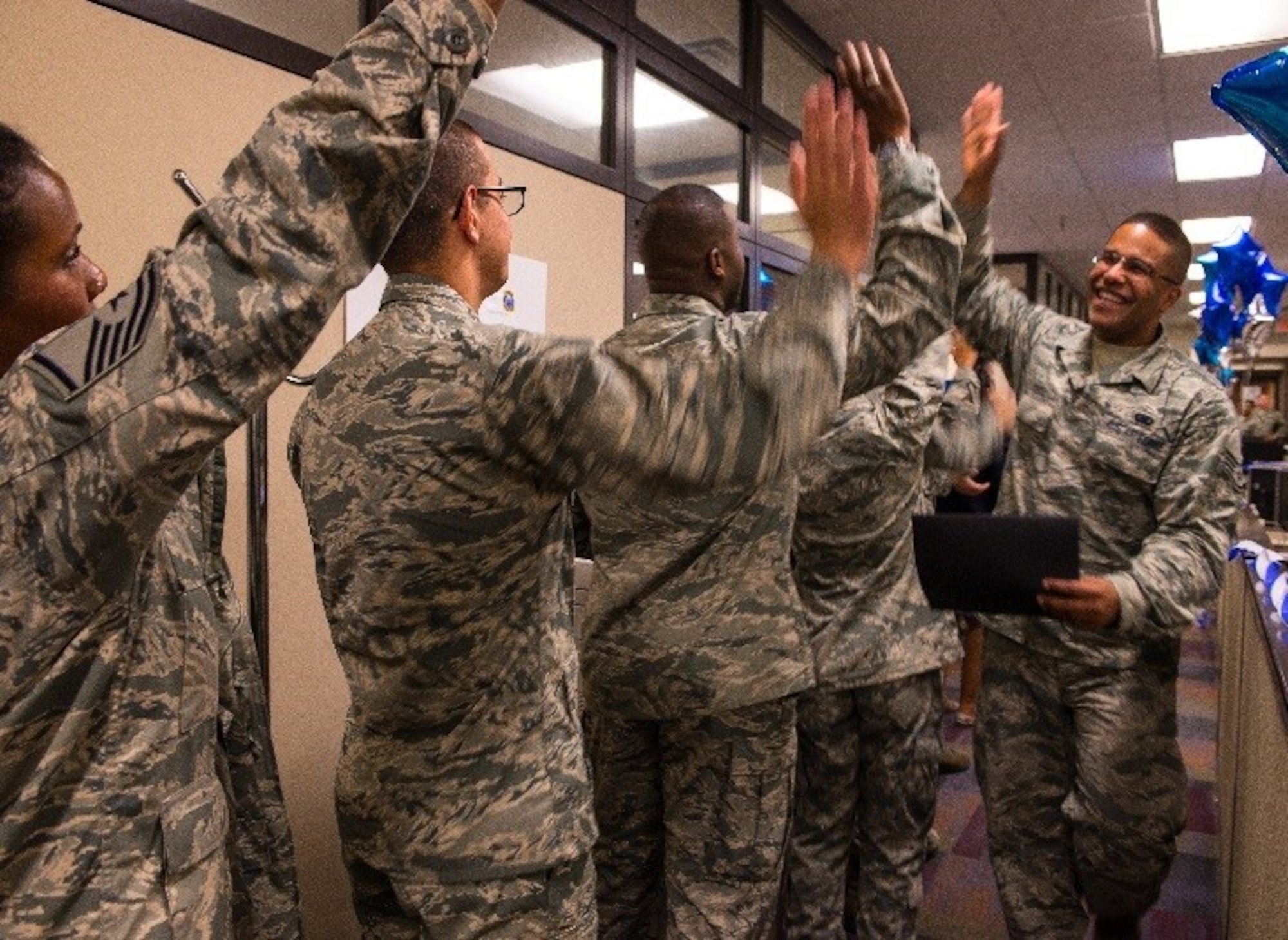 Airmen cheer and trade high-fives as team members are recognized during the 440th Supply Chain Operations Squadron Equipment Transformation graduation at Joint Base Langley-Eustis, Va., Oct. 6, 2016. More than 100 Airmen were awarded diplomas after logging over 2,000 training hours to improve processes and better serve maintainers at U.S. Air Force bases worldwide. (U.S. Air Force photo by Danny Mangosing)