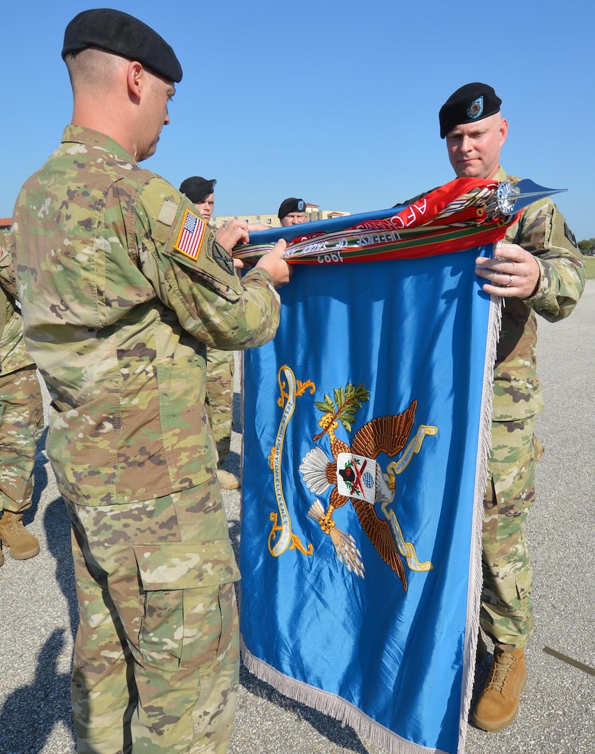 201st Military Intelligence Battalion Command Sgt. Maj. Jason Davis (right) joins Lt. Col. David Violand (left), 201st Military Intelligence Battalion commander, in casing the battalion’s colors.  