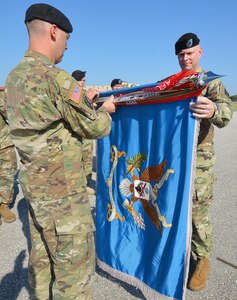 201st Military Intelligence Battalion Command Sgt. Maj. Jason Davis (right) joins Lt. Col. David Violand (left), 201st Military Intelligence Battalion commander, in casing the battalion’s colors.  