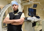 Maj. David Winter, 59th Medical Wing medical physicist, poses in front of medical equipment in the Wilford Hall Ambulatory Surgical Center, Joint Base San Antonio-Lackland, Texas, June 16, 2016. Winter is in charge of operating a diverse array of imaging machinery that detects and combats cancer in patients.