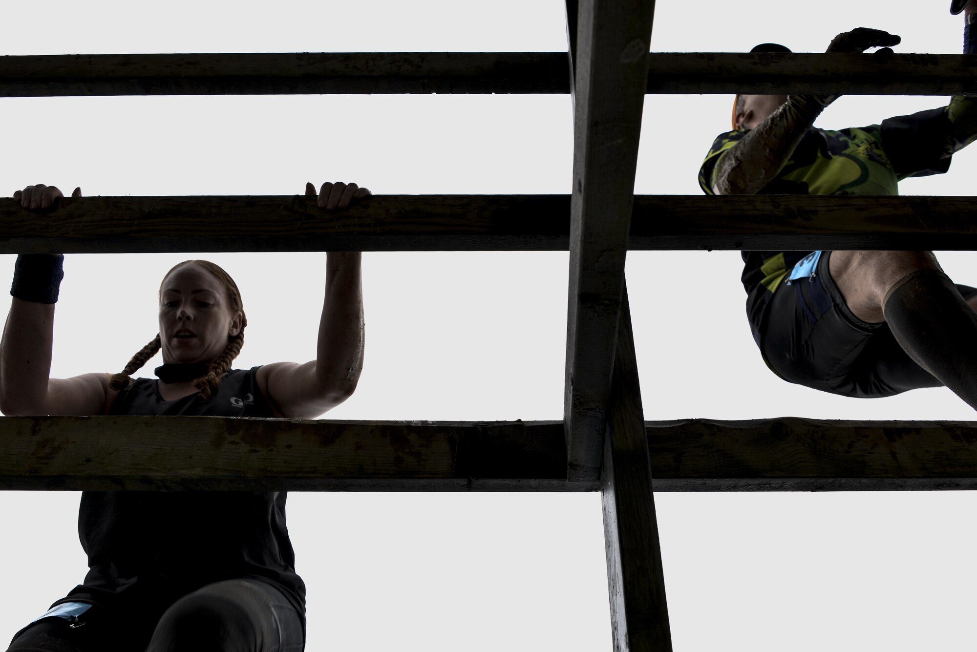 Meghan Root, 70th Intelligence, Surveillance and Reconnaissance Wing Sexual Assault Response Coordinator, climbs a wooden fence obstacle in the 2016 Savage Race October 8, 2016 at Kennedyville, Md. 70th ISRW participants endured a seven-mile obstacle course of cargo net walls, creeks, ice cold water and climbing to test their stamina and strength as a team. (U.S. Air Force photo/Staff Sgt. Alexandre Montes)