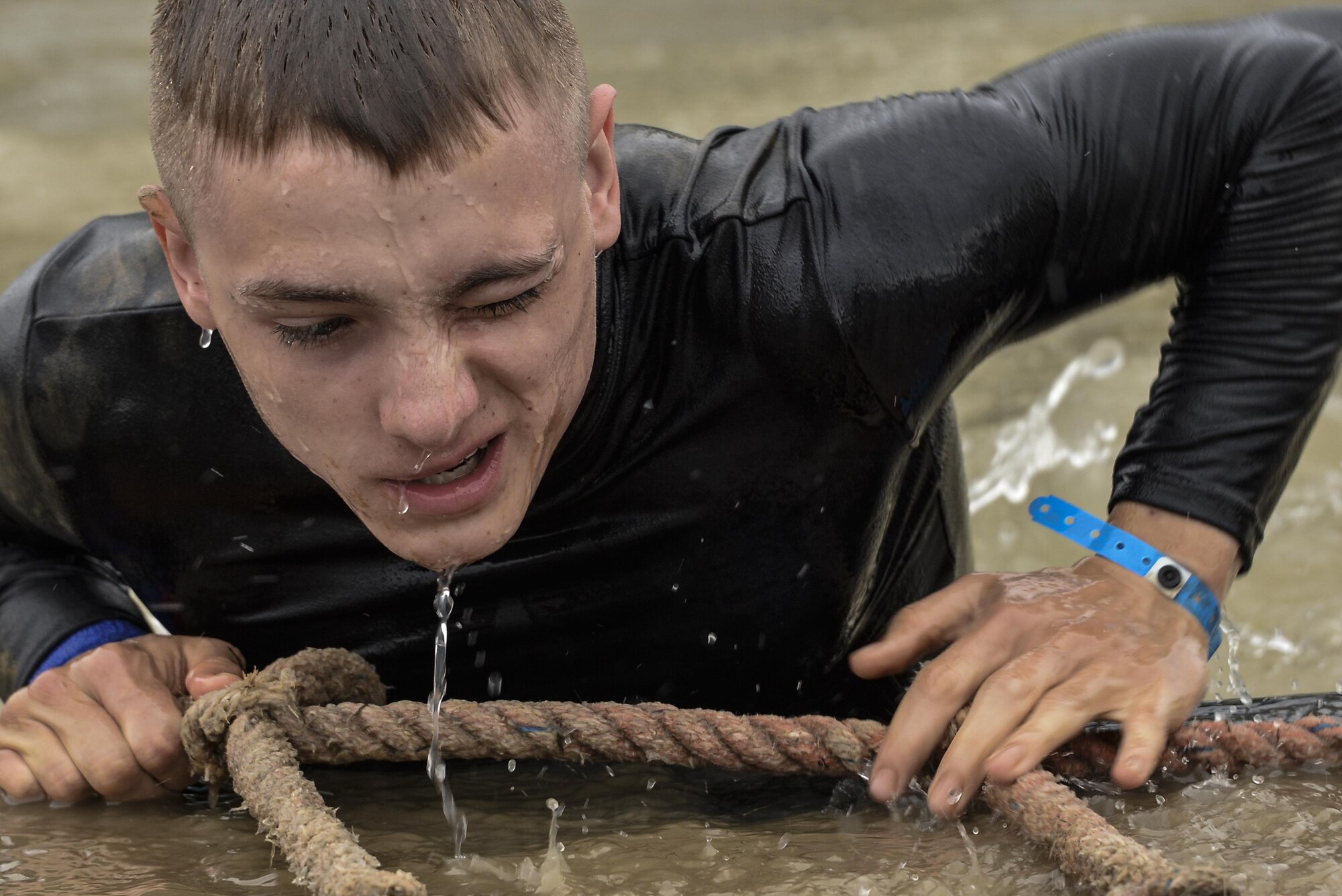 Jackson Hensley climbs out of ‘Davey Jones’ Locker’, a 15 foot drop to a 15 foot deep pool obstacle during the 2016 Savage Race October 8, 2016 at Kennedyville, Md. 70th ISRW participants endured a seven-mile obstacle course of cargo net walls, creeks, ice cold water and climbing to test their stamina and strength as a team. (U.S. Air Force photo/Staff Sgt. Alexandre Montes)