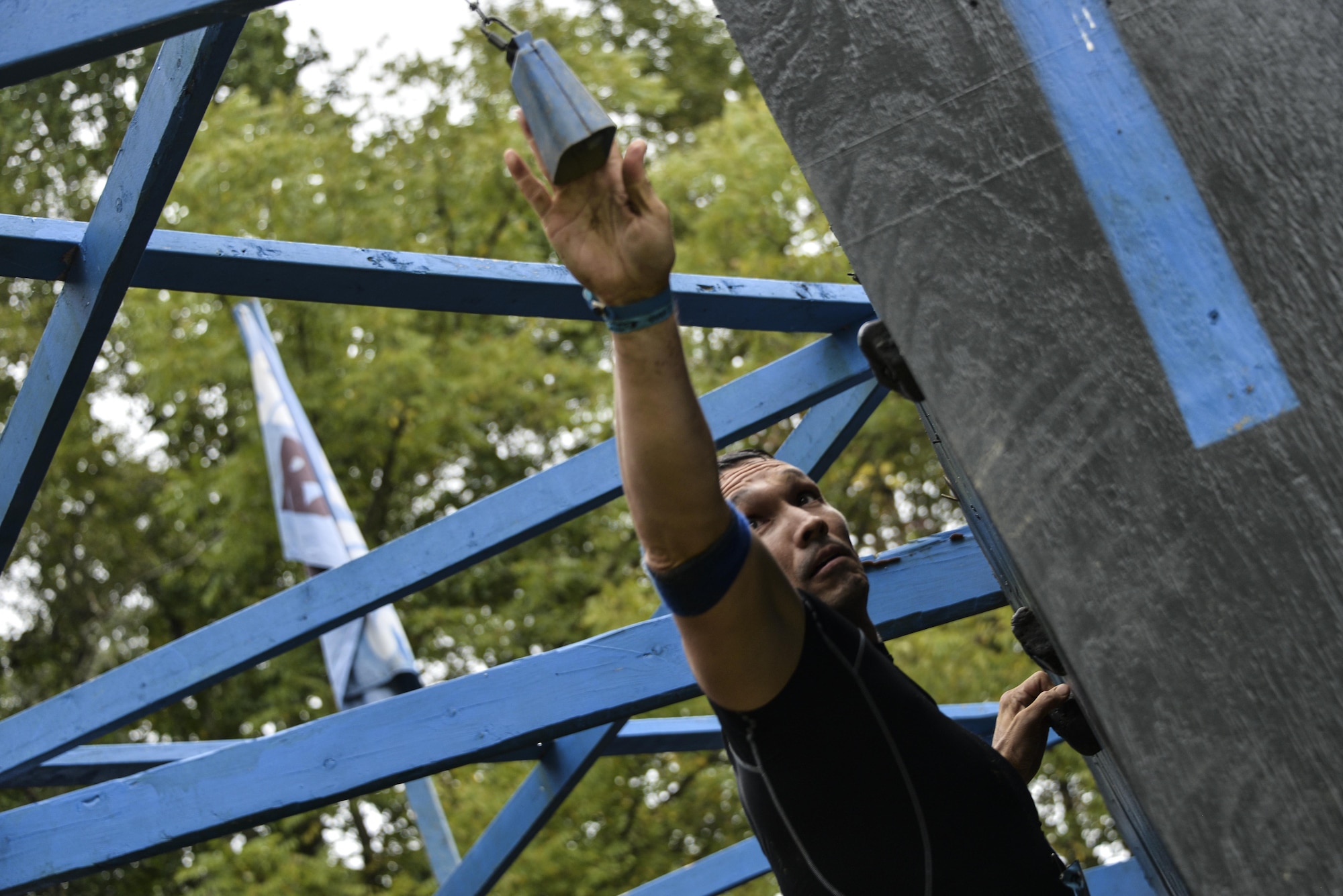 Col. Thomas Hensley, 70th Intelligence, Surveillance and Reconnaissance Wing commander, completes a rock climbing wall with only a one-inch gap along a 25-foot wall during the 2016 Savage Race October 8, 2016 at Kennedyville, Md. 70th ISRW participants endured a seven-mile obstacle course of cargo net walls, creeks, ice cold water and climbing to test their stamina and strength as a team. (U.S. Air Force photo/Staff Sgt. Alexandre Montes)