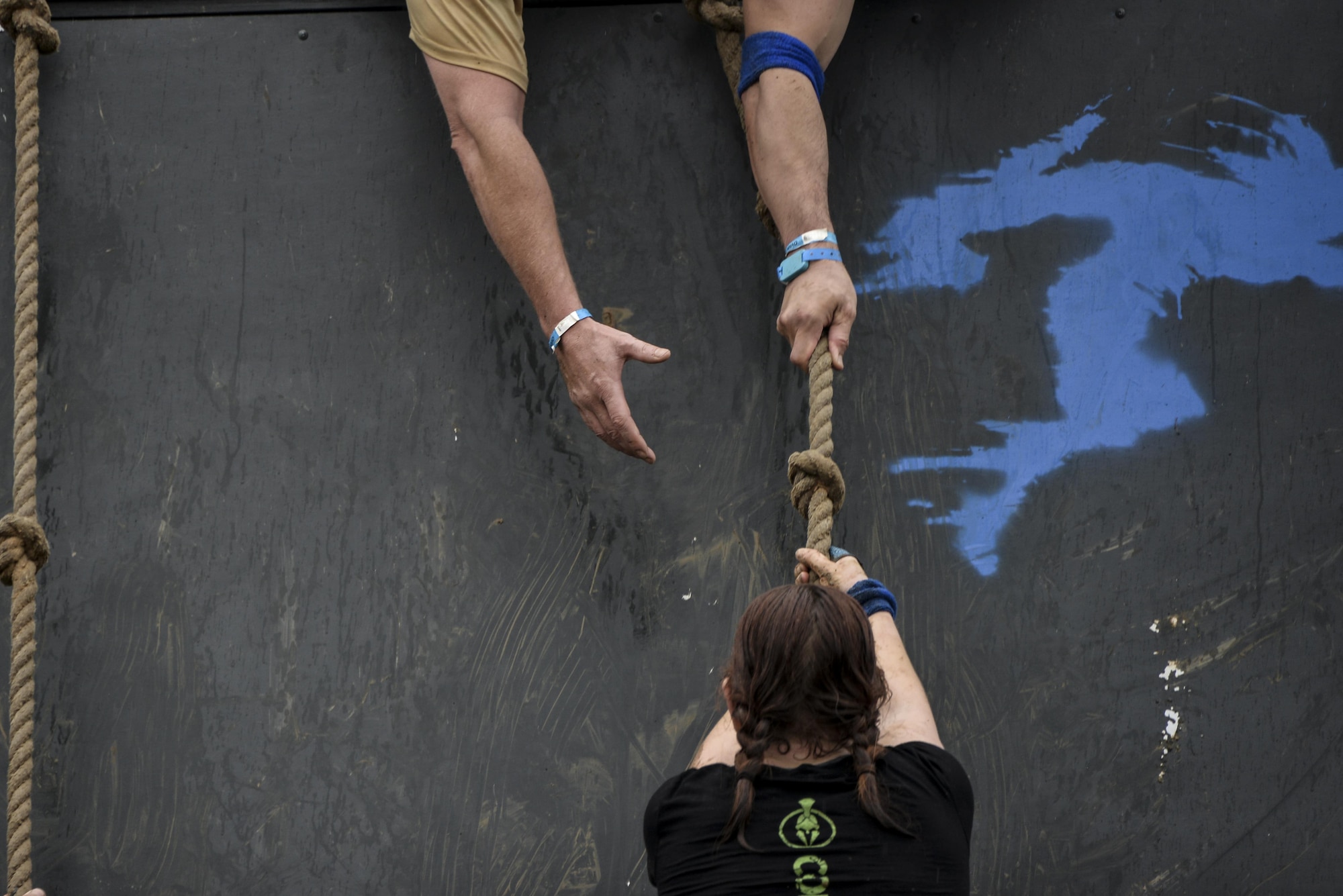 Capt. Lorinda, 7th intelligence Squadron, climbs up a 43-foot quarter pipe wall during the final stages of the 2016 Savage Race October 8, 2016 at Kennedyville, Md. 70th ISRW participants endured a seven-mile obstacle course of cargo net walls, creeks, ice cold water and climbing to test their stamina and strength as a team. (U.S. Air Force photo/Staff Sgt. Alexandre Montes)