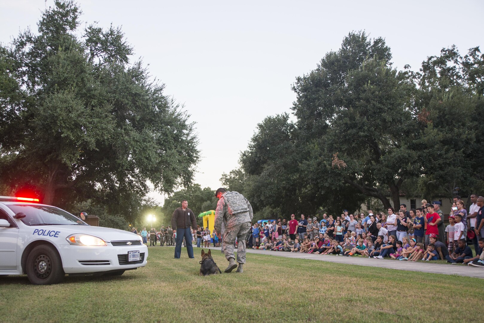 Members from the 902nd Security Forces Squadron give a military working dog demonstration during National Night Out at Joint Base San Antonio-Randolph Oct. 4, 2016. The 902nd SFS is home to six MWDs, each has explosives and narcotics training as part of their weekly duties. 
