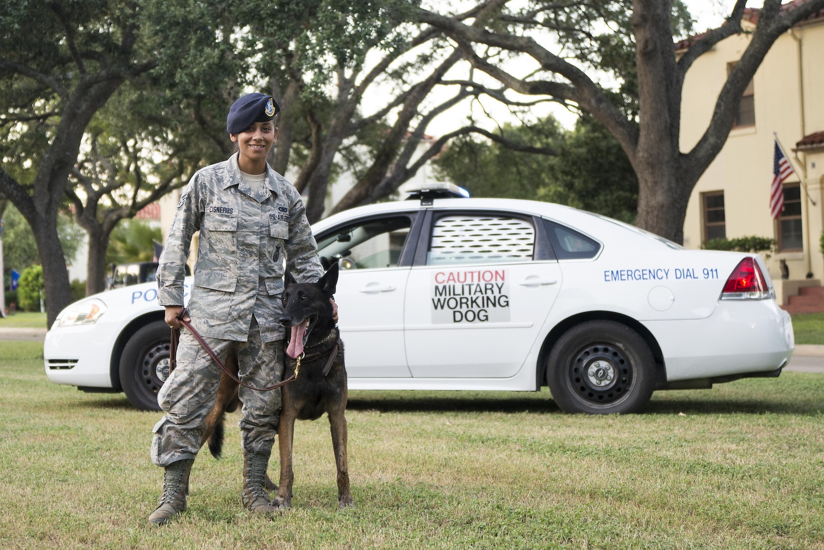 Senior Airman Ivette Cisneros, 902nd Security Forces Squadron military working dog handler, prepares to participate in a MWD demonstration with her dog, Vudu, at National Night Out at Joint Base San Antonio-Randolph Oct. 4, 2016. The 902nd SFS is home to six MWDs; each dog has explosives and narcotics training as part of their weekly duties.