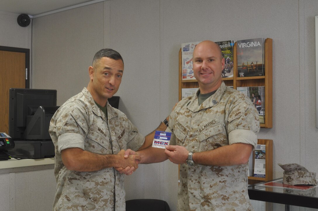 Colonel Murray presents Master Sgt. Chad Anderson with a $50 Marine
Corps Exchange Gift Certificate courtesy of the Quantico Outdoor Adventures
Center for bagging the first deer of the season aboard MCB Quantico.