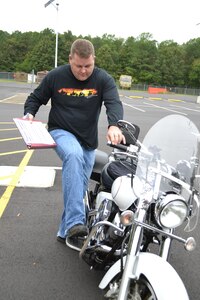 Sgt. 1st Class Eric Baker, motorcycle mentor for the 80th Training Command (TASS), goes through a motorcycle safety checklist at the command's Family Programs Center in Richmond, Va., as he prepares for the motorcycle mentorship ride in honor of Sgt. Scott McGinnis on Oct. 6, 2016. McGinnis, 22, died in a motorcycle accident July 4, 2016 in Centre, Ala., where he was struck by another vehicle.