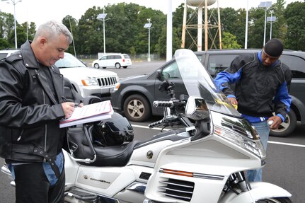 (Left to right) Maj. Stephen Yarber and Master Sgt. Gregory Moody, of the 80th Training Command (TASS), conduct a safety check of Moody's bike at the command's Family Programs Center in Richmond, Va., as they prepare for the motorcycle mentorship ride in honor of Sgt. Scott McGinnis on Oct. 6, 2016. McGinnis, 22, died in a motorcycle accident July 4, 2016 in Centre, Ala., where he was struck by another vehicle.