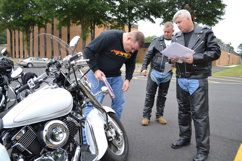 (Left to right) Sgt. 1st Class Eric Baker, Sgt. 1st Class David Mangan and Maj. Stephen Yarber, of the 80th Training Command (TASS), conduct motorcycle safety checks at the command's Family Programs Center in Richmond, Va., as they prepare for the motorcycle mentorship ride in honor of Sgt. Scott McGinnis on Oct. 6, 2016. McGinnis, 22, died in a motorcycle accident July 4, 2016 in Centre, Ala., where he was struck by another vehicle.