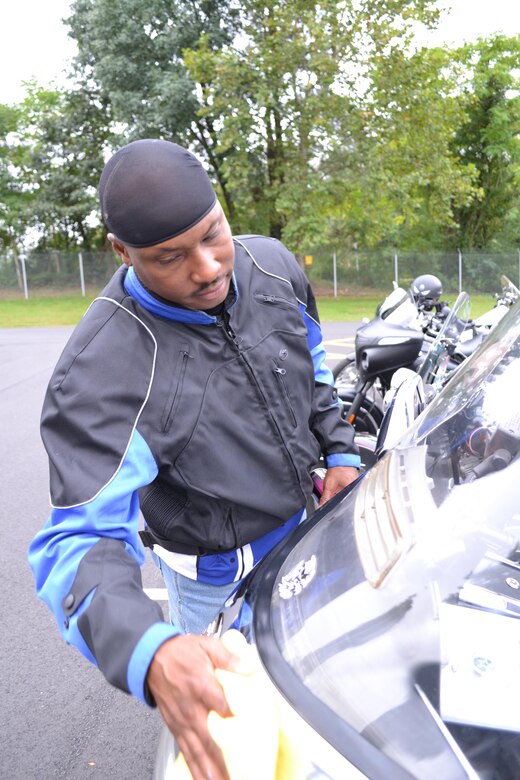 Master Sgt. Gregory Moody, contracting officer representative for the 80th Training Command (TASS), cleans his motorcycle at the command's Family Programs Center in Richmond, Va., as he prepares for the motorcycle mentorship ride in honor of Sgt. Scott McGinnis on Oct. 6, 2016. McGinnis, 22, died in a motorcycle accident July 4, 2016 in Centre, Ala., where he was struck by another vehicle.