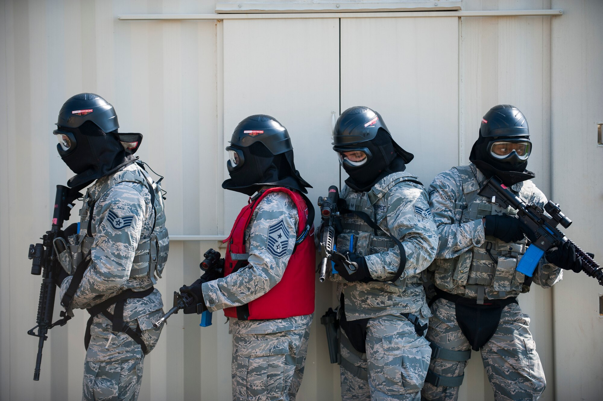 Air Mobility Command Command Chief Master Sgt. Shelina Frey (in the red vest) participates in responding to an active shooter exercise at the 375th Security Forces Squadron’s shoot house, which provides realistic training on a variety of situations. (U.S. Air Force photo/Staff Sgt. Clayton Lenhardt)