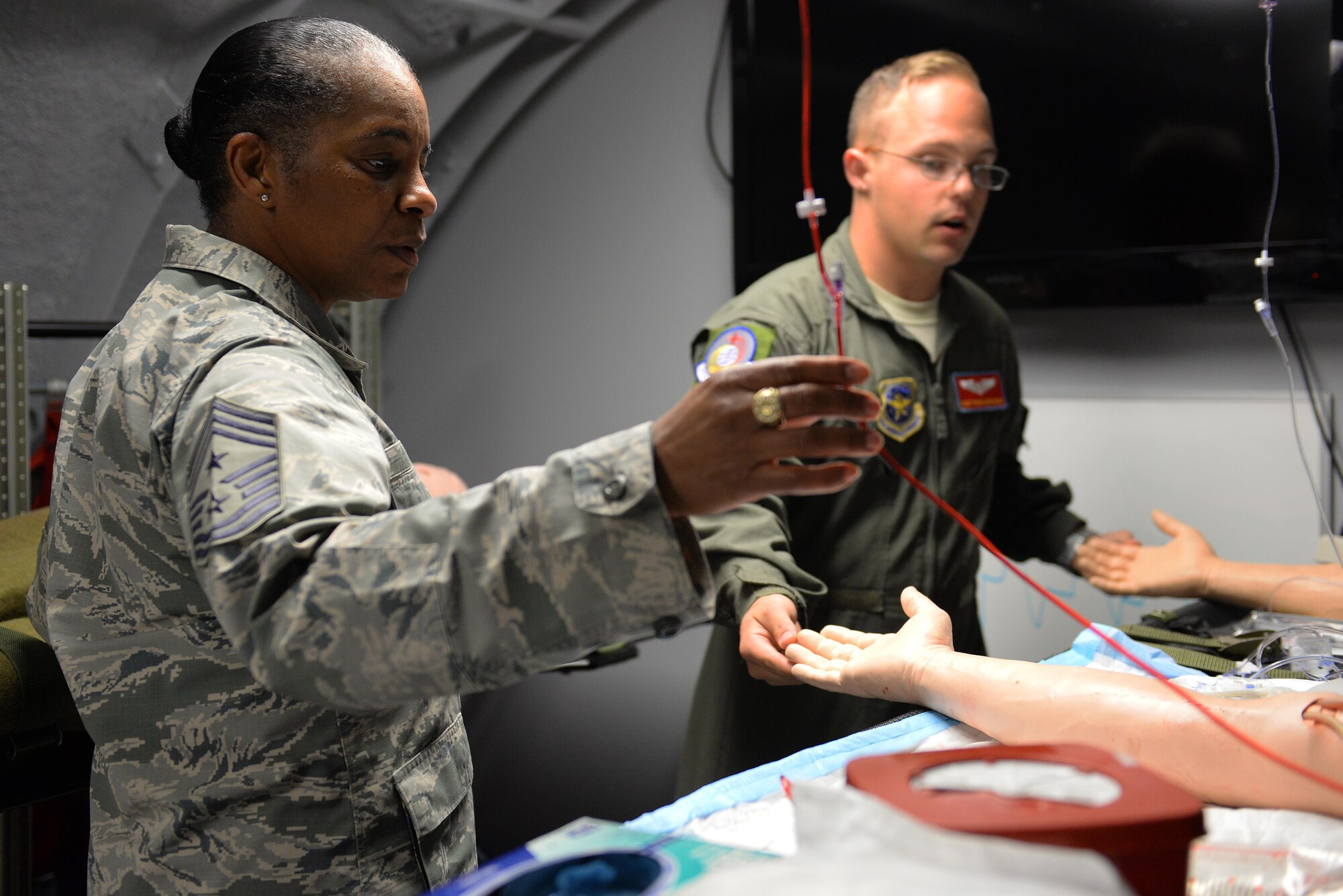 Air Mobility Command Command Chief Master Sgt. Shelina Frey learns about the 375th Aeromedical Evacuation Squadron’s training platforms from Staff Sgt. Ryan Edwards, 375th AES. (U.S. Air Force photo/Senior Airman Erica Fowler)