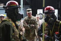 Army Maj. Gen. Richard Gallant, commander of Joint Task Force Civil Support, center, watches as Marines with Search and Extraction Platoon, Chemical Biological Incident Response Force (CBIRF), enter a simulated contaminated building to search for casualties during an official visit at Naval Annex Stump Neck, Md., Sept. 29, 2016. Gallant visited CBIRF’s own training site to learn more about the Marines and sailors with CBIRF, their training and operational capabilities,  and the equipment they use for chemical, biological, radiological, nuclear and high-yield explosive (CBRNE) crisis response and consequence management. (Official U.S. Marine Corps photo by Sgt. Jonathan Herrera/Released)