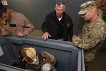 Patrick Higgins, lead civilian instructor for Downey Responder Training Facility with Chemical Biological Incident Response Force (CBIRF), explains to Army Maj. Gen. Richard Gallant, commander of Joint Task Force Civil Support, how CBIRF Marines learn to perform emergency action drills with their self-contained breathing apparatus (SCBA) during an official visit at Naval Annex Stump Neck, Md., Sept. 29, 2016. Gallant visited CBIRF’s own training site to learn more about the Marines and sailors with CBIRF, their training and operational capabilities,  and the equipment they use for chemical, biological, radiological, nuclear and high-yield explosive (CBRNE) crisis response and consequence management. (Official U.S. Marine Corps photo by Sgt. Jonathan Herrera/Released)