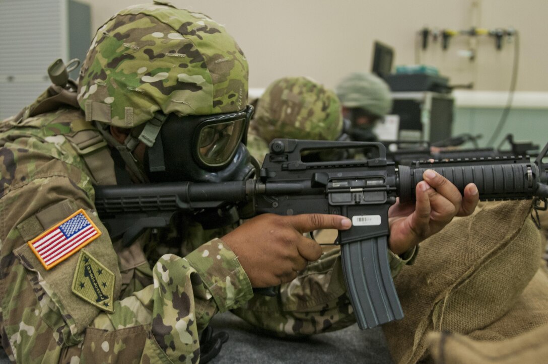 Staff Sgt. Christopher Hector, an Army Reserve Soldier with the 316th Sustainment Command (Expeditionary), based out of Coraopolis, Pa., shoots his M4 carbine with a ProMask during training at the Equipment Simulation Training 2000 at Fort Hood, Tx., Oct. 9, 2016. This is to prepare the Soldiers of the 316th during their predeployment training. (U.S. Army photo by Staff Sgt. Dalton Smith / Released)