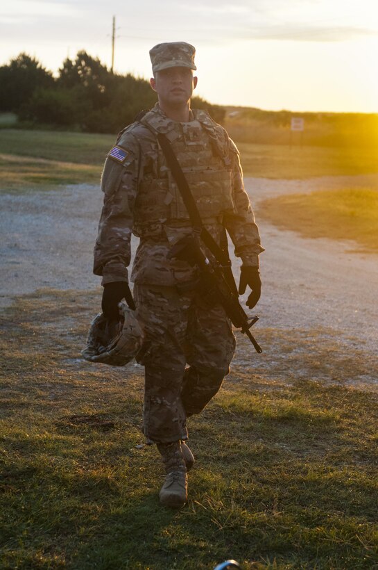 Sgt. Christopher Bigelow, a public affairs noncommissioned officer with the 316th Sustainment Command (Expeditionary), based out of Coraopolis, Pa., walks onto a range to qualify with his M4 carbines at Fort Hood, Tx., Oct. 9, 2016. (U.S. Army photo by Staff Sgt. Dalton Smith / Released)