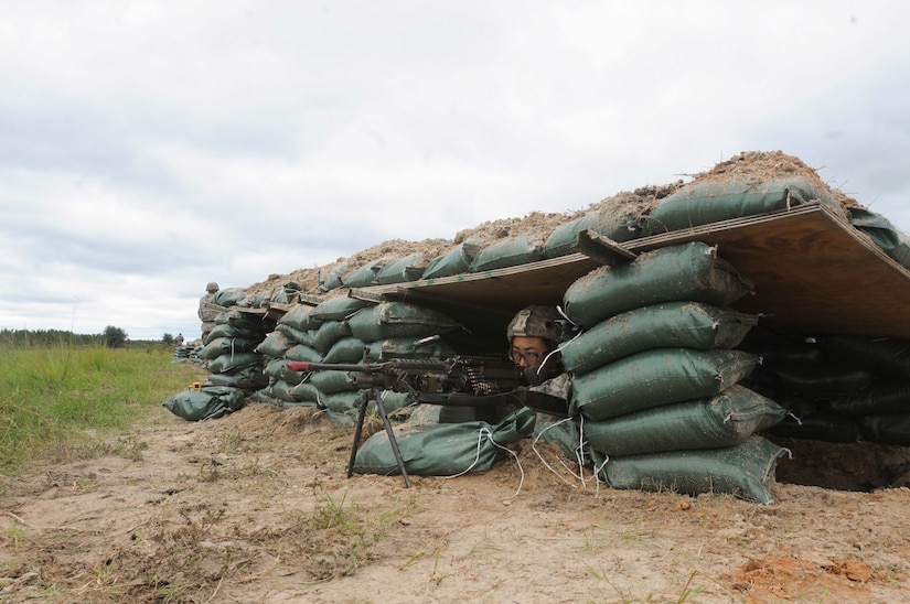 Army Pfc. Li Ma, a finance specialist with the 24th Finance Management Support Unit, scans her sector of fire during a base defense field exercise at Fort Stewart, Ga., Sept. 19, 2016. Army photo by Sgt. 1st Class Ben K. Navratil