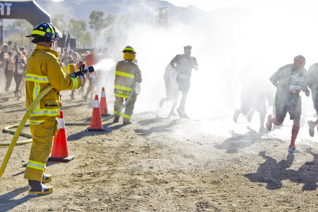 LAKE ELSINORE- Calif. (October 8, 2016) -
Army Reserve firefighters Sgt. Joshua Panlilio and Spc. Armando Garduno, 163rd Ordinance Company, shower the SoCal Tough Mudder participants as they take on the 22-obstacle course over ten miles long.

(US Army photo by Cpl. Timothy Yao)