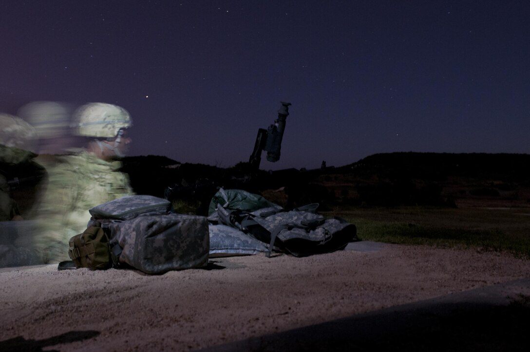 An Army Reserve Soldier looks down range before qualifying with the M240B machine gun during night qualification at Fort Hood, Tx., Oct. 10, 2016. This is to prepare the Soldiers of the 316th during their predeployment training. (U.S. Army photo by Staff Sgt. Dalton Smith)