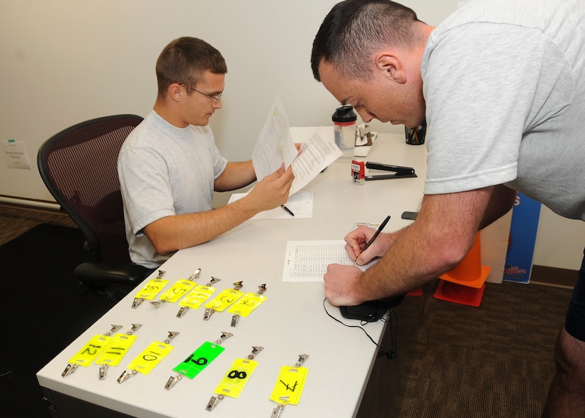 Senior Airman Nathan Zick, 2nd Logistics Readiness Squadron Fitness Assessment cell member, registers Airmen before their fitness assessment at the Senior Airman Bryan R. Bell Fitness Center on Barksdale Air Force Base, La., Oct. 11, 2016. The Air Force uses an overall composite fitness score and minimum scores per component based on aerobic fitness, body composition and muscular fitness components to determine an overall fitness score. (U.S. Air Force photo/Airman Alexis C. Schultz