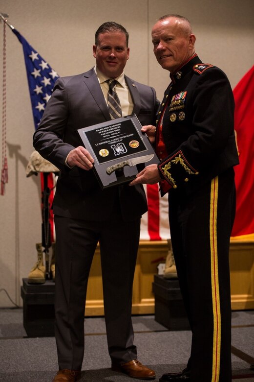 Lt. Gen. Lawrence D. Nicholson (right), commanding general of III Marine Expeditionary Force, is presented a plaque by Matthew Chase, retired Gunnery Sergeant, 1st Battalion, 25th Marine Regiment, 4th Marine Division, during 25th Marine Regiment’s 10-year reunion of their deployment to Fallujah, Iraq, here, Oct. 8, 2016. Nicholson was the guest of honor at the reunion and spoke to the Marines and Sailors about the importance of looking out for each other and preserving the brotherhood that was developed during their deployment. (U.S. Marine Corps photo by Cpl. Melissa Martens/ Released) 