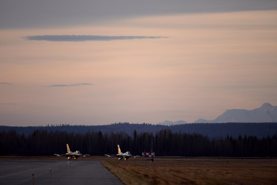 U.S. Air Force F-16 Fighting Falcons assigned to the 18th Aggressor Squadron wait to take off from Eielson Air Force Base, Alaska, Oct. 10, 2016, during RED FLAG-Alaska (RF-A) 17-1. RF-A is a series of Pacific Air Forces commander-directed field training exercises, enabling joint and international units to sharpen their skills by flying simulated combat sorties in a realistic threat environment inside the Joint Pacific Alaska Range Complex, the largest instrumented air, ground and electronic combat training range in the world. (U.S. Air Force photo by Master Sgt. Karen J. Tomasik)