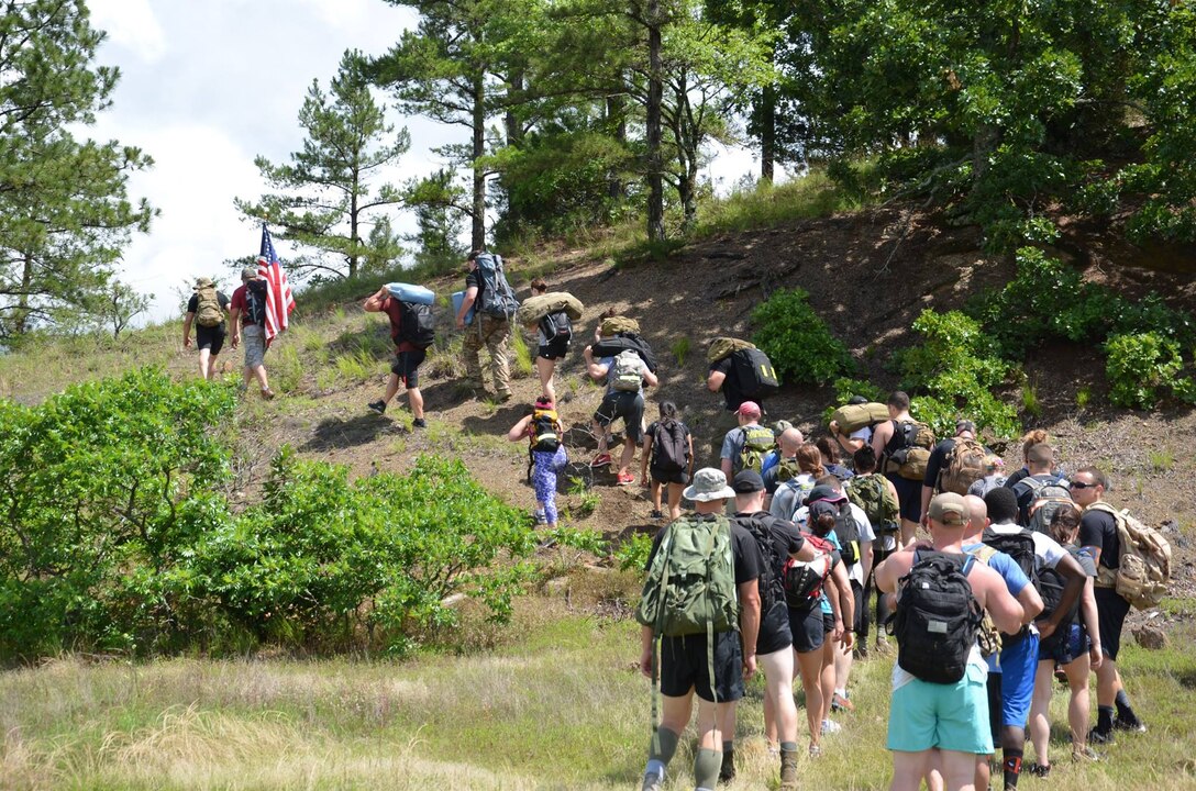 Participants, including Tech. Sgt. Robert Hattan, do hill climbs during the GORUCK USAF Team Cohesion Challenge event held at Little Rock Air Force Base, Arkansas, June 4, 2016.  GORUCK events require participants to work as a team to overcome obstacles along a five to seven mile course, all while wearing a weighted backpack. (Courtesy photo)
