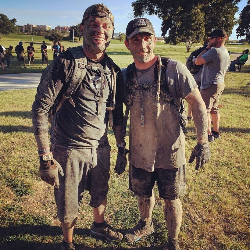 Tech. Sgt. Robert Hattan, right, and a teammate covered in mud after participating in a GORUCK event. 
