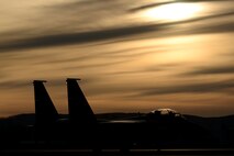 A Republic of Korea Air Force (ROKAF) F-15K Slam Eagle multi-role fighter aircraft taxis down the Eielson Air Force Base, Alaska, flight line as the sun rises behind a layer of clouds Oct. 10, 2016, during RED FLAG-Alaska (RF-A) 17-1. RF-A is a series of Pacific Air Forces commander-directed field training exercises for U.S. and partner nation forces like the ROKAF, enabling joint and international units to sharpen their skills by flying simulated combat sorties in a realistic threat environment inside the Joint Pacific Alaska Range Complex, the largest instrumented air, ground and electronic combat training range in the world. (U.S. Air Force photo by Master Sgt. Karen J. Tomasik)