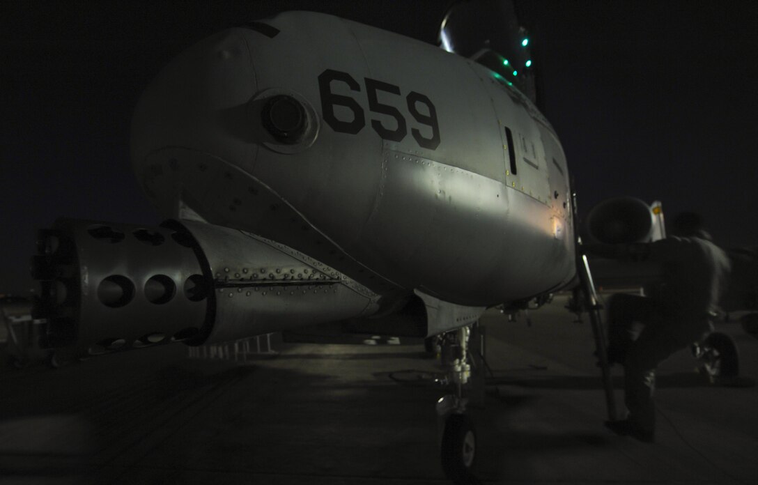 Senior Airman Scott Martinez, 355th Aircraft Maintenance Squadron crew chief, Davis-Monthan Air Force Base, Ariz., climbs down the side of an A-10 Thunderbolt II before takeoff at Nellis Air Force Base, Nev., Oct. 4, 2016. The A-10 has excellent maneuverability at low air speeds and altitude, and is a highly accurate and survivable weapons-delivery platform. (U.S. Air Force photo by Airman 1st Class Kevin Tanenbaum/Released)
