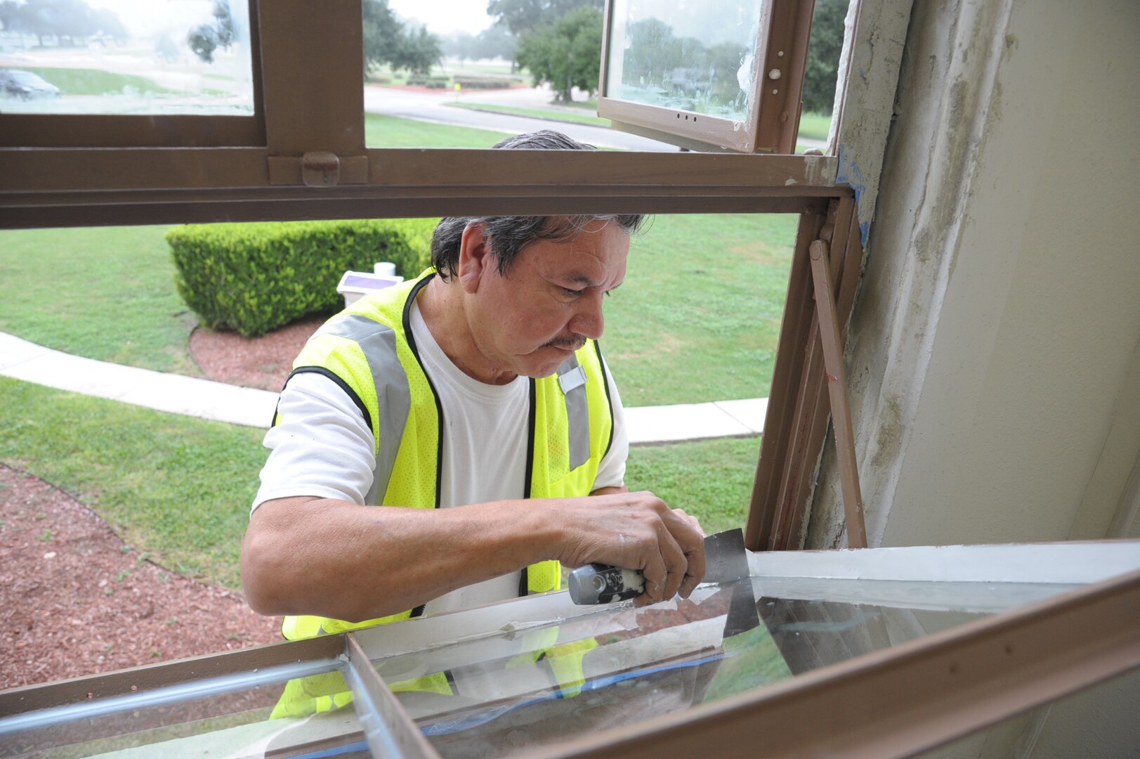Eddie Contreras glazes a window at the Joint Base San Antonio-Randolph Taj Mahal, during its renovation process Oct. 6, 2016.  The renovation is part of a $10 million project designed the improve the Taj Mahal, which houses the headquarters for the 12th Flying Training Wing and the 12th Mission Support Group.  