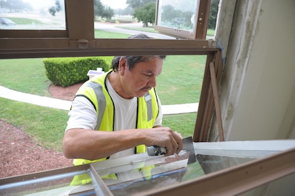 Eddie Contreras glazes a window at the Joint Base San Antonio-Randolph Taj Mahal, during its renovation process Oct. 6, 2016.  The renovation is part of a $10 million project designed the improve the Taj Mahal, which houses the headquarters for the 12th Flying Training Wing and the 12th Mission Support Group.  