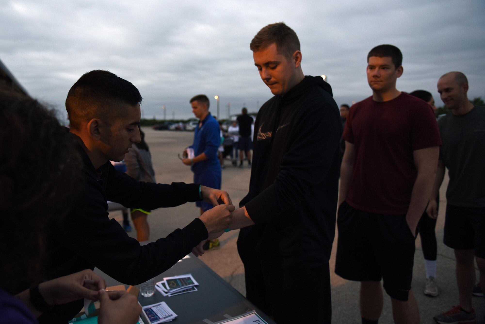 U.S. Air Force 2nd Lt. Ryan Davis, 315th Training Squadron student, signs in for the annual Sexual Assault Prevention and Response Color Run near the Kiowa Trail on Goodfellow Air Force Base, Texas, Oct. 8, 2016. The SAPR office gave the participants free white t-shirts for the run in order to spread sexual assault awareness. (U.S. Air Force photo by Airman 1st Class Caelynn Ferguson/Released)
